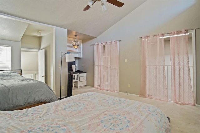 bedroom with ceiling fan with notable chandelier and vaulted ceiling