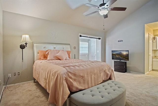 bedroom with lofted ceiling, ensuite bath, ceiling fan, and light carpet