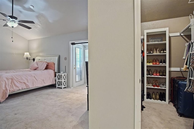 bedroom featuring lofted ceiling, light colored carpet, and ceiling fan