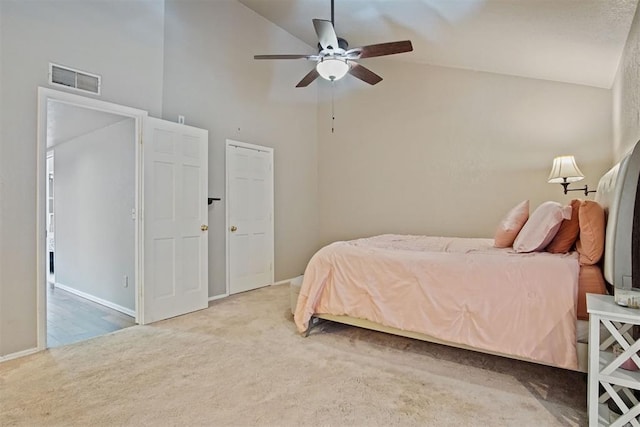 carpeted bedroom featuring ceiling fan and high vaulted ceiling