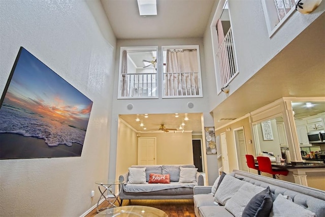 interior space with a high ceiling and ceiling fan