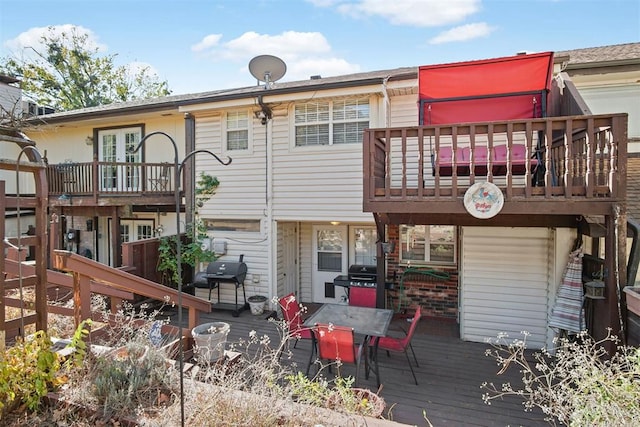 back of property featuring a wooden deck