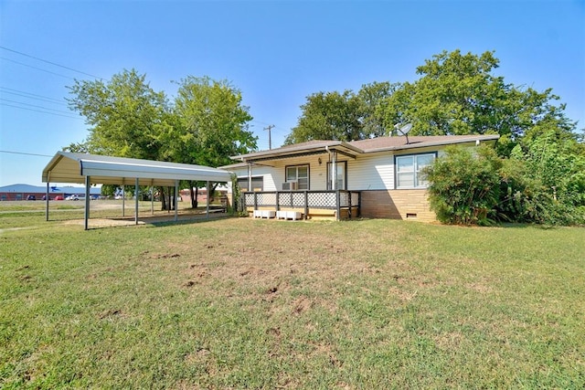 rear view of property featuring a carport, covered porch, and a yard