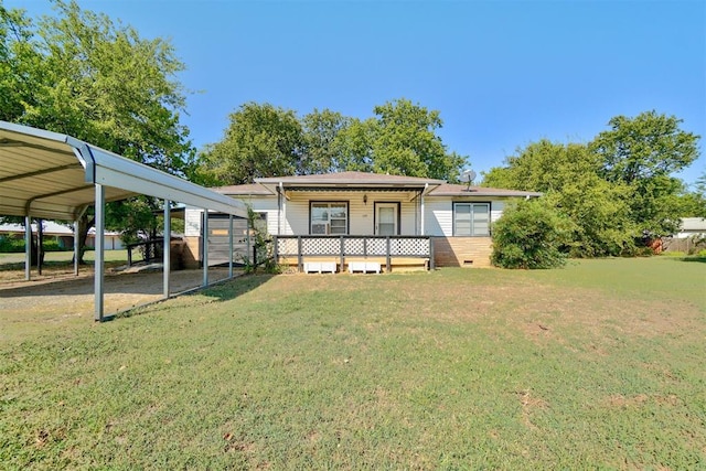 rear view of property with a porch, a carport, and a lawn