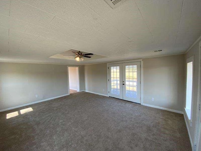 carpeted empty room featuring ceiling fan, french doors, and a textured ceiling