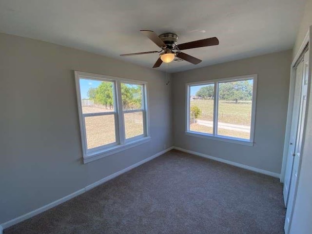 carpeted empty room with ceiling fan