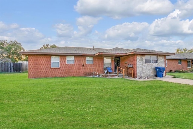 back of property featuring a lawn