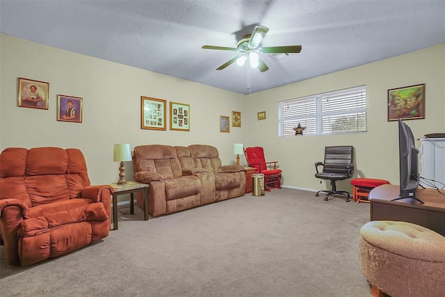 living room with carpet flooring, ceiling fan, and a textured ceiling