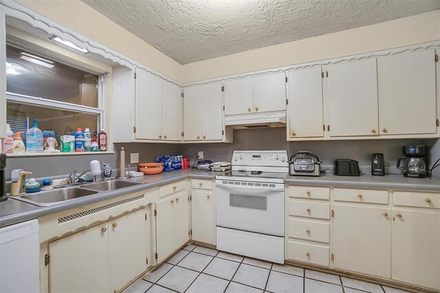 kitchen with a textured ceiling, white appliances, sink, light tile patterned floors, and white cabinets