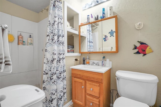 bathroom featuring vanity and toilet