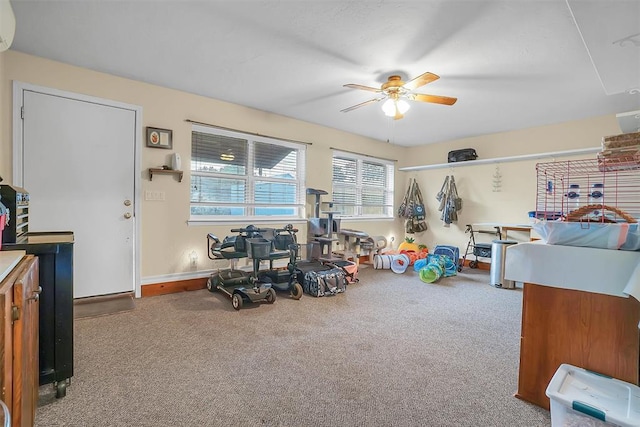 interior space featuring carpet, ceiling fan, and a wall unit AC