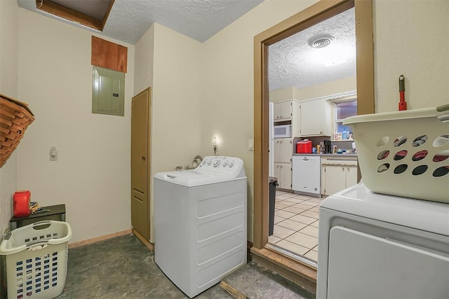 laundry area featuring washing machine and dryer, a textured ceiling, and electric panel