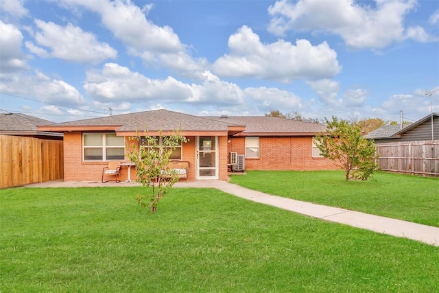 back of house with a lawn and a patio area