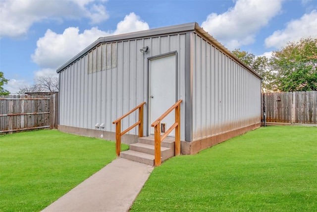 view of outbuilding featuring a yard