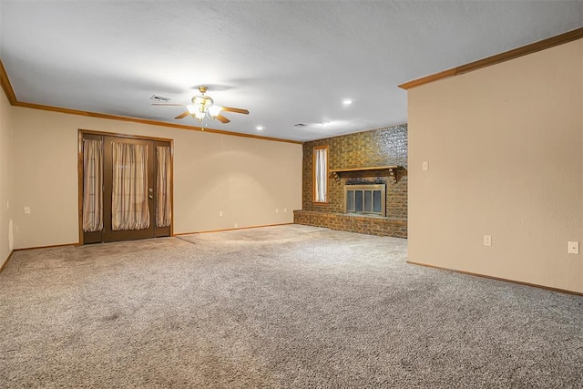 unfurnished living room with a brick fireplace, ceiling fan, carpet floors, and ornamental molding