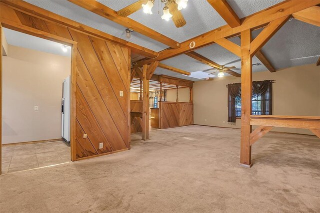 420 W 8th St, Cordell, OK 73632 - below grade area with ceiling fan, wooden walls, refrigerator with ice dispenser, carpet floors, and baseboards