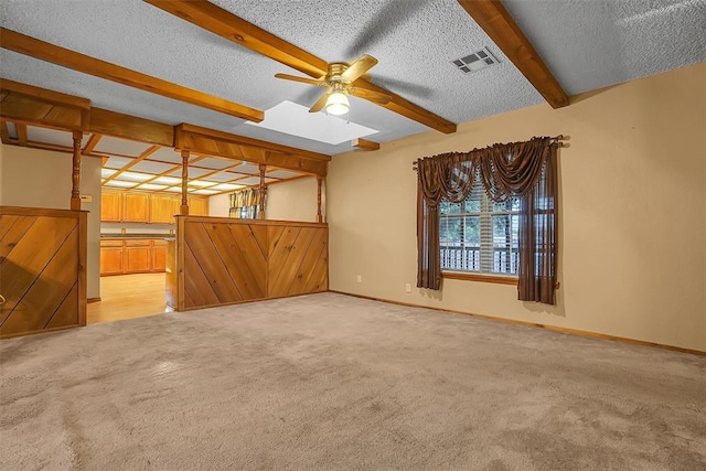420 W 8th St, Cordell, OK 73632 - unfurnished room featuring light carpet, a ceiling fan, beamed ceiling, a textured ceiling, and baseboards