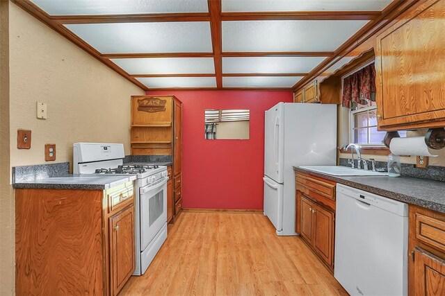 420 W 8th St, Cordell, OK 73632 - kitchen featuring white appliances, a sink, dark countertops, brown cabinetry, and a textured wall