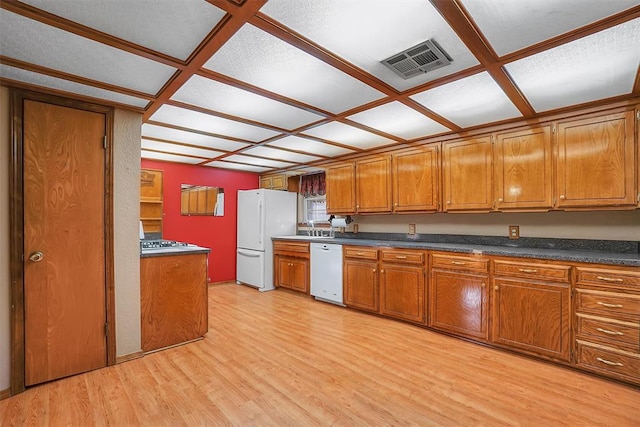 kitchen featuring white appliances, light hardwood / wood-style flooring, coffered ceiling, and sink