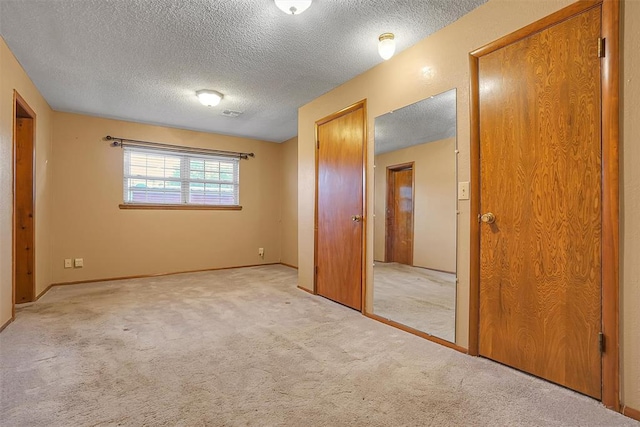 420 W 8th St, Cordell, OK 73632 - unfurnished bedroom with a textured ceiling, light carpet, a closet, and baseboards
