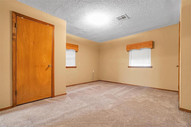 420 W 8th St, Cordell, OK 73632 - carpeted empty room with a textured ceiling and baseboards