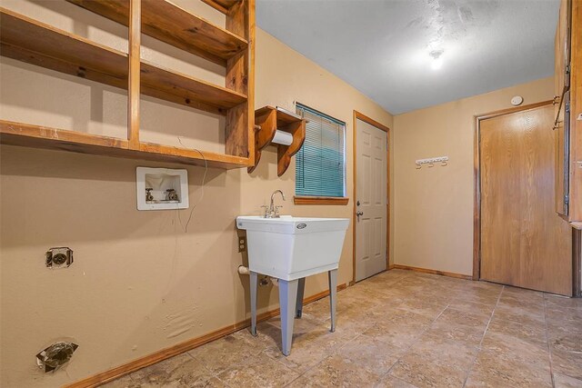 420 W 8th St, Cordell, OK 73632 - laundry room with washer hookup, baseboards, and light stone finish flooring