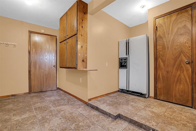 kitchen featuring white fridge with ice dispenser