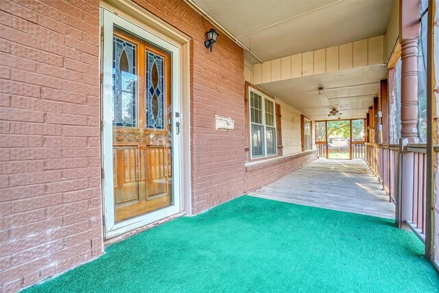 420 W 8th St, Cordell, OK 73632 - property entrance featuring a porch and brick siding