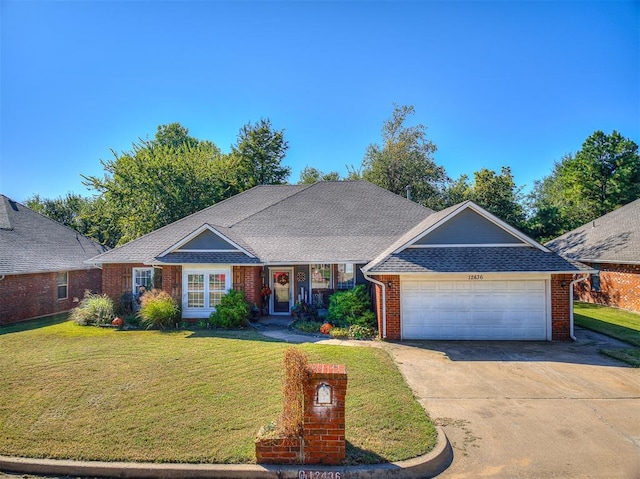 ranch-style house featuring a garage and a front lawn