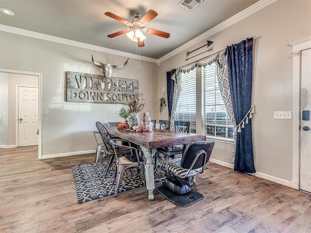 dining room with crown molding, hardwood / wood-style floors, and ceiling fan