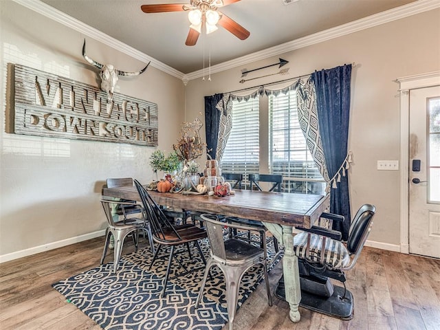 dining room featuring crown molding, hardwood / wood-style floors, and ceiling fan