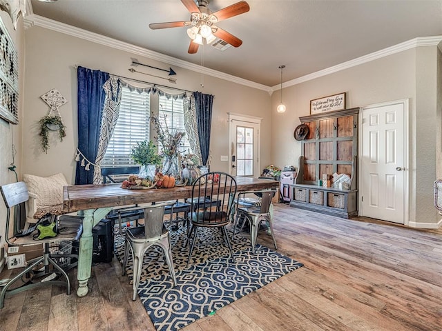 dining area with hardwood / wood-style flooring, ceiling fan, and crown molding