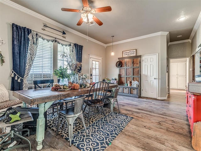 dining area featuring hardwood / wood-style flooring, ceiling fan, and ornamental molding