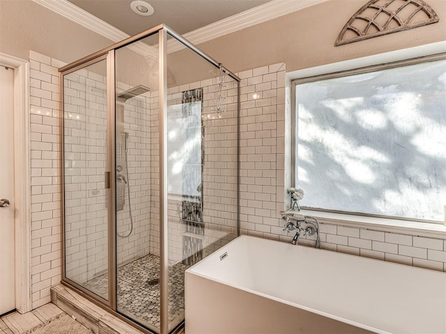 bathroom with shower with separate bathtub and ornamental molding