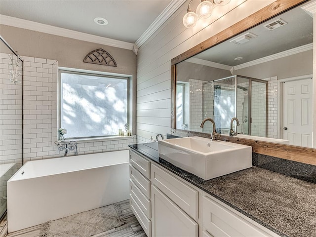 bathroom featuring wood walls, vanity, separate shower and tub, and ornamental molding