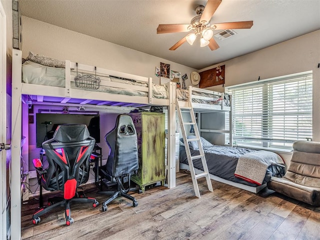 bedroom featuring hardwood / wood-style flooring and ceiling fan