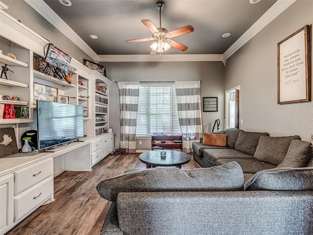 living room with crown molding, ceiling fan, built in desk, a textured ceiling, and dark hardwood / wood-style flooring