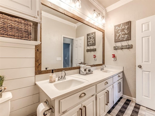 bathroom with vanity, toilet, and crown molding