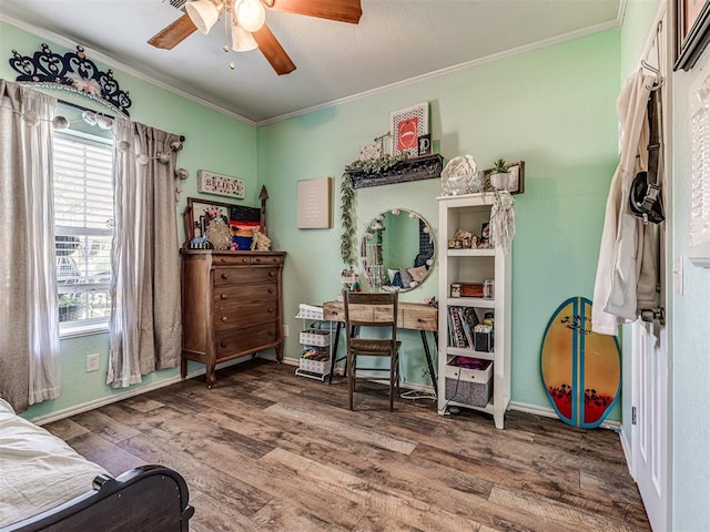 bedroom with ceiling fan, wood-type flooring, and ornamental molding