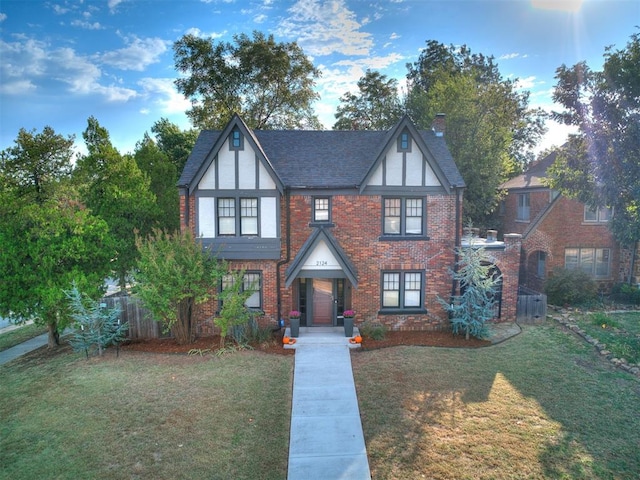 tudor-style house with a front lawn