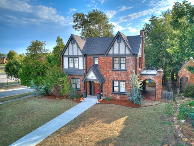 tudor home with a front yard