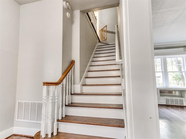 staircase with hardwood / wood-style flooring