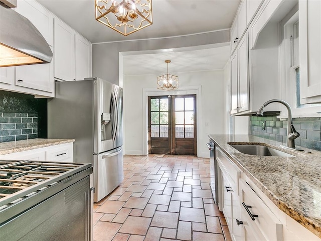 kitchen featuring white cabinets, sink, and tasteful backsplash