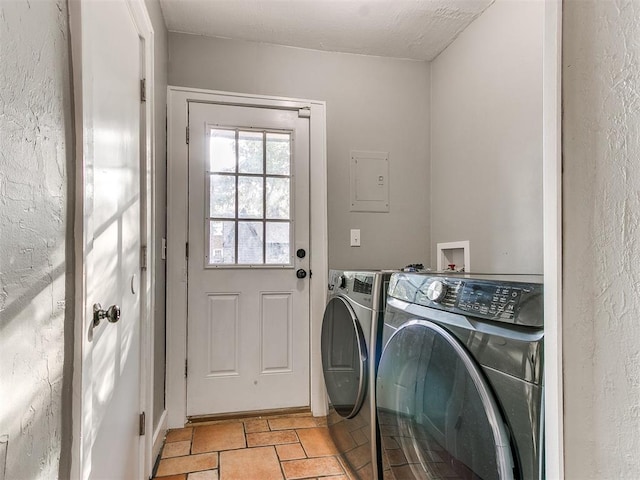 laundry area featuring washing machine and clothes dryer and a textured ceiling