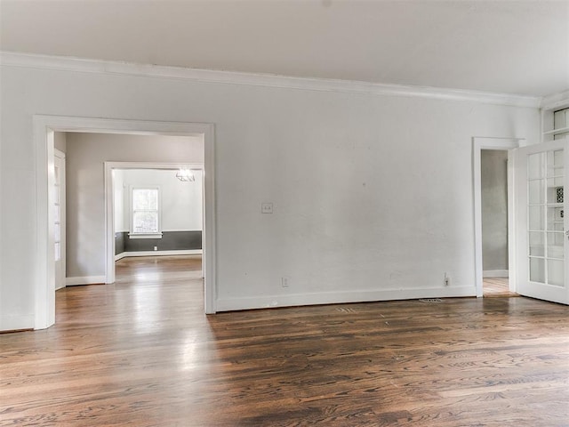 empty room featuring dark hardwood / wood-style flooring and crown molding