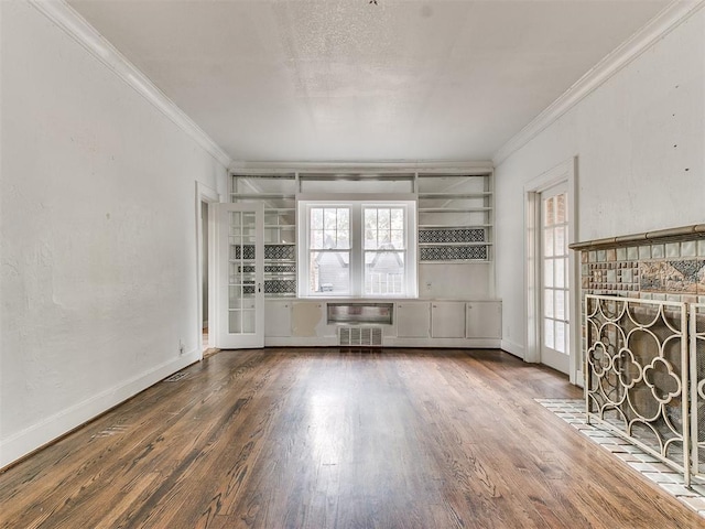 unfurnished living room with a healthy amount of sunlight, dark hardwood / wood-style floors, and ornamental molding