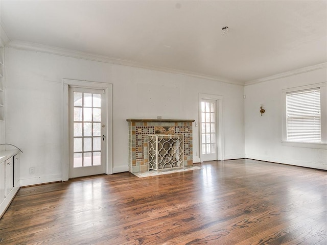 unfurnished living room with dark hardwood / wood-style floors, ornamental molding, and a fireplace