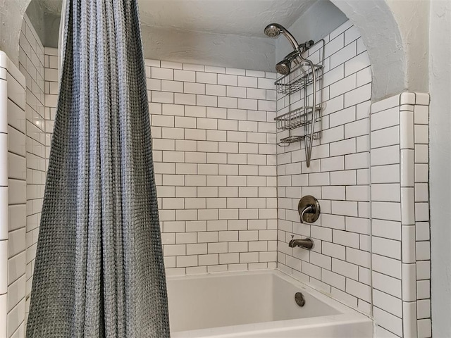 bathroom with shower / bathtub combination with curtain