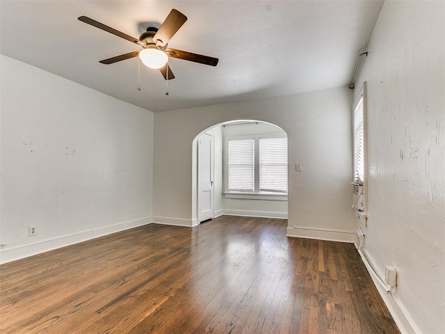 empty room featuring ceiling fan and dark hardwood / wood-style flooring