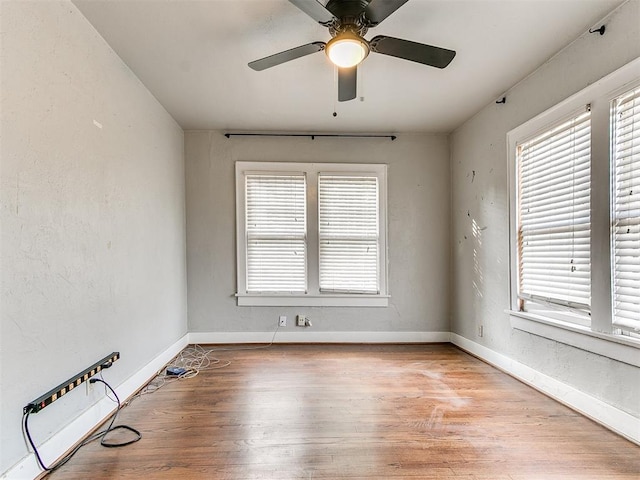 spare room featuring ceiling fan and light wood-type flooring